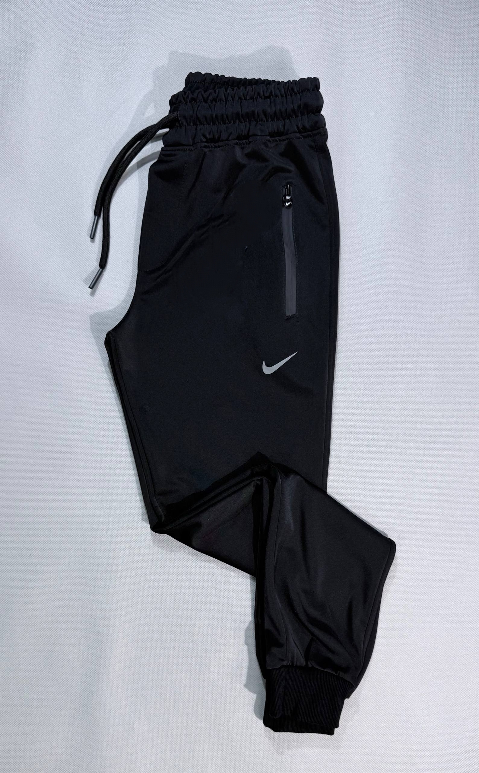 شلوار ورزشی مردانه مدل NIKE پارچه غواصی دمپا کش جیب دار تک رنگ مشکی